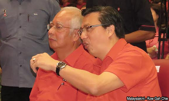 MCA president Liow Tiong Lai whispers in Najib's ear